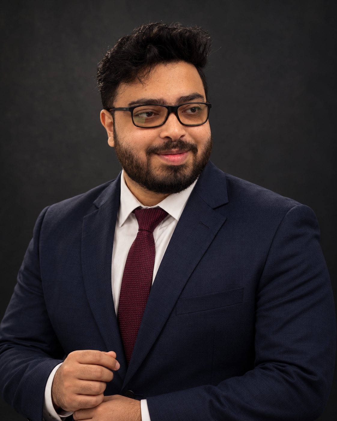 Amitrosudan Basu in a navy suit and burgundy tie